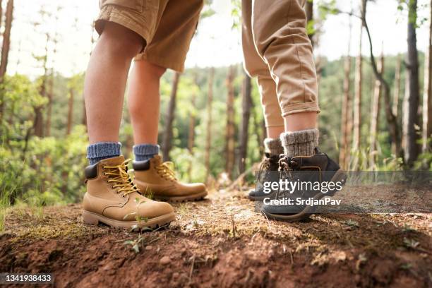 close-up of unrecognizable female hiker standing on tiptoe with her boyfriend in the woods - foot kiss stock pictures, royalty-free photos & images