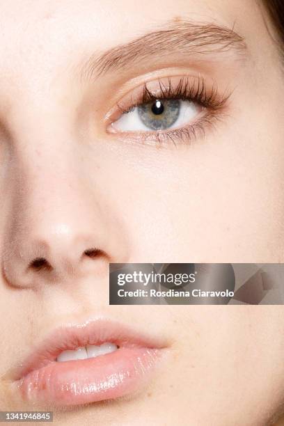 Model Giselle Norman, make up detail, poses in the backstage of the Jil Sander fashion show during the Milan Fashion Week - Spring / Summer 2022 on...