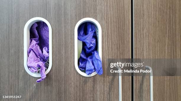 medical examination gloves in a dispenser - latex glove stock pictures, royalty-free photos & images