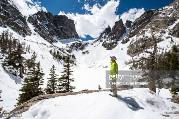 man hiking in snowy mountains - estes park stock pictures, royalty-free photos & images