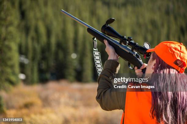 female hunter aiming rifle, colorado, usa - front range mountain range bildbanksfoton och bilder