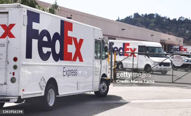 FedEx trucks are parked at a FedEx Ship Center on September 22, 2021 in Los Angeles, California. FedEx plans to increase shipping rates in 2022 with...