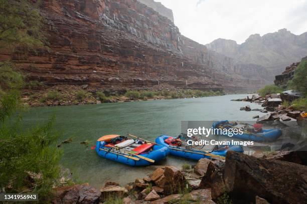 a sudden rain storm catches rafters on the colorado river at the grand canyon in arizona. - grand canyon rafting stock pictures, royalty-free photos & images
