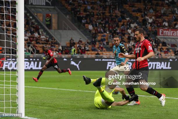 Cristian Molinaro of Venezia FC looks on as team mate and goalkeeper Niki Maenpaa dives at the fette of Alessandro Florenzi of AC Milan to deny the...