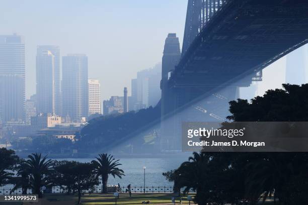 The Sydney Harbour Bridge and city buildings shrouded in thick smoke on September 23, 2021 in Sydney, Australia. Smoke haze has covered parts of...