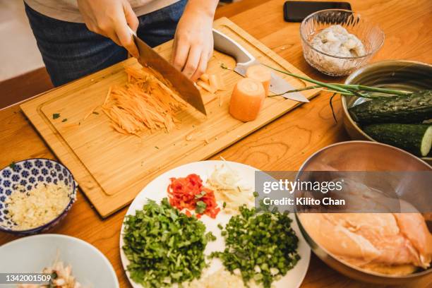 asian woman making healthy food using a lot of fresh ingredients - east asia stock pictures, royalty-free photos & images