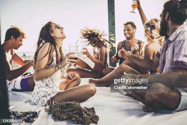 happy friends having fun on beach bed in summer day. - beach cocktail party stock pictures, royalty-free photos & images