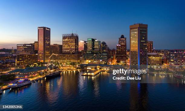 baltimore skyline and inner harbor aerial at dusk - baltimore stock pictures, royalty-free photos & images