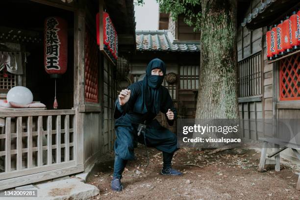 ninja warrior in a traditional japanese village - ninja stock pictures, royalty-free photos & images