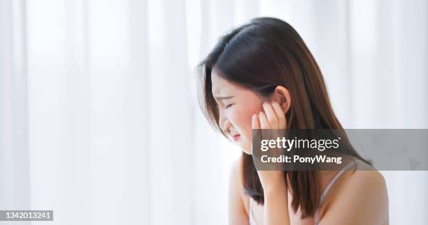 donna che si gratta il viso - woman scratching face foto e immagini stock