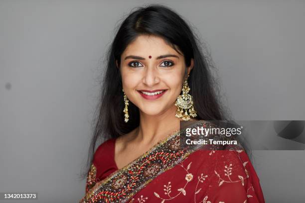 an indian woman dressed in traditional clothes. - sari isolated stock pictures, royalty-free photos & images