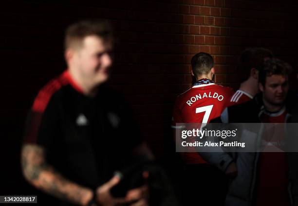 Fan wearing the shirt of Cristiano Ronaldo makes their way to the stadium prior to the Carabao Cup Third Round match between Manchester United and...