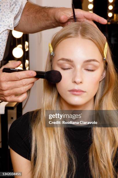 Model is seen during make up in the backstage of the Genny fashion show during the Milan Fashion Week - Spring / Summer 2022 on September 23, 2021 in...