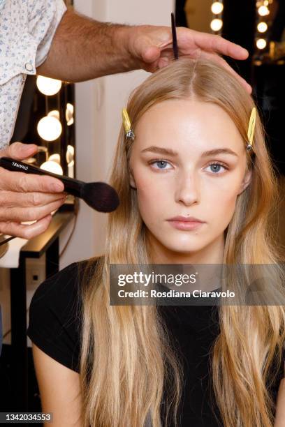 Model is seen during make up in the backstage of the Genny fashion show during the Milan Fashion Week - Spring / Summer 2022 on September 23, 2021 in...