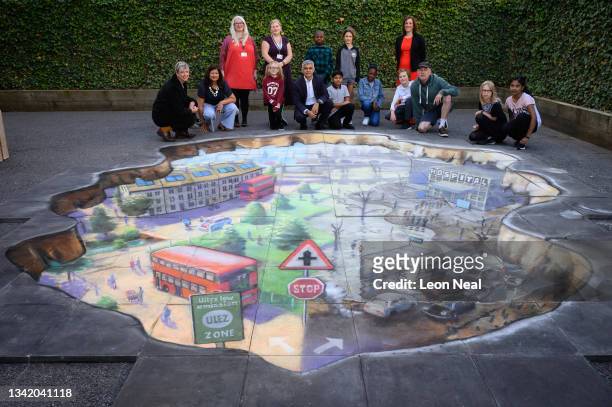 Mayor of London Sadiq Khan poses with pupils and teachers next to artwork by Julian Beever during a photocall at Prior Weston primary school before...