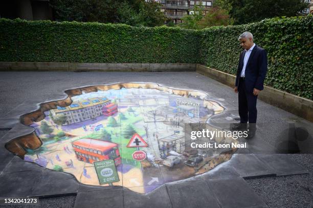 Mayor of London Sadiq Khan poses with artwork by Julian Beever during a photocall at Prior Weston primary school before delivering a speech on his...