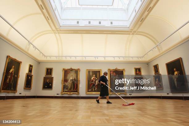 Heather Bundy gallery worker sweeps the floor in the Ramsay room at the Scottish National Portrait Gallery, following a £17.6million restoration...