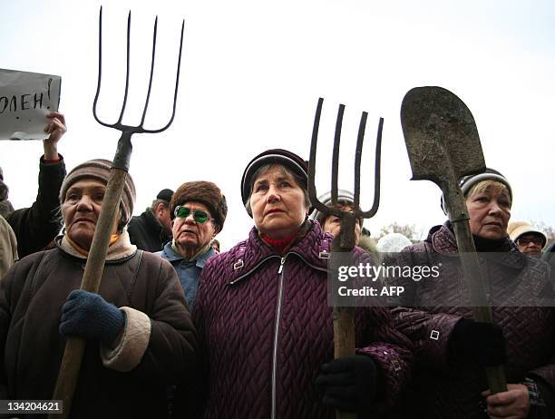 Elderly protesters hold pitchforks and spades during a rally in front of the city's administration building in Donetsk on November 28, 2011. People...