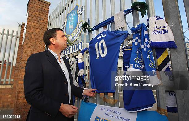 Ex Everton player Graeme Sharp looks at tributes to footballer and ex Everton player Gary Speed outside Goodison Park the home ground of Everton FC...