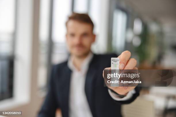 businessman showing a negative rapid antigen test - coronavirus slovenia stock pictures, royalty-free photos & images