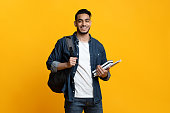 Smart arab guy student with backpack and books