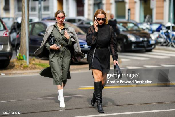 Guest wears red sunglasses, silver earrings, a large gold chain necklace, a khaki oversized long shirt dress, a gray and white print pattern...