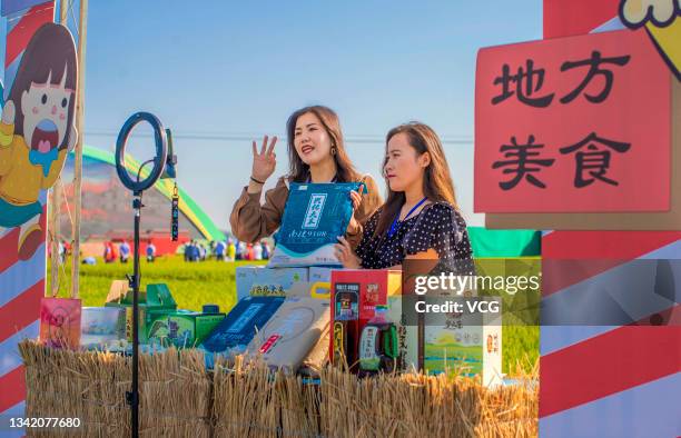 Farmers promote local rice at a grain industrial park via live streaming to welcome the 4th Chinese Farmers' Harvest Festival on September 22, 2021...