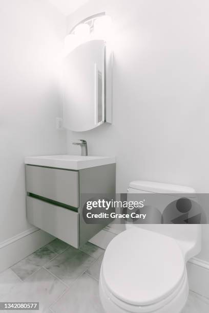 floating vanity and toilet in domestic bathroom - bathroom vanity fotografías e imágenes de stock