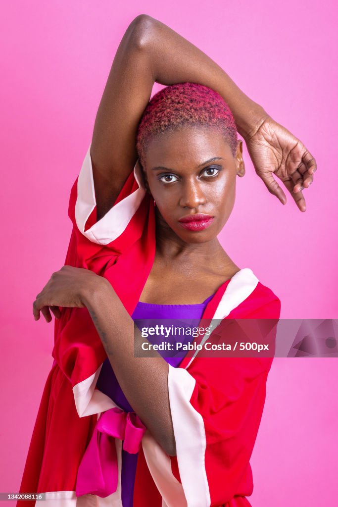 Portrait of woman standing against pink background,Buenos Aires,Argentina
