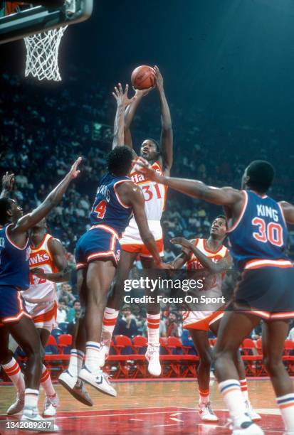 Rickey Brown of the Atlanta Hawks shoots against the New York Knicks during an NBA basketball game circa 1984 at the Omni Coliseum in Atlanta,...