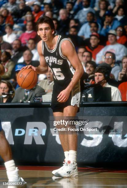 Vinny Del Negro of the San Antonio Spurs dribbles the ball against the Washington Bullets during an NBA basketball game circa 1992 at the Capital...