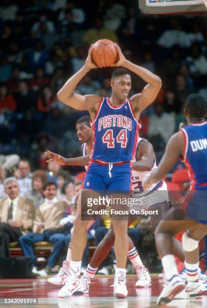 Rick Mahorn of the Detroit Pistons looks to pass the ball against the Washington Bullets during an NBA basketball game circa 1985 at the Capital...