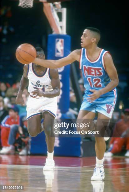 Tate George of the New Jersey Nets dribbles the ball up court against the Washington Bullets during an NBA basketball game circa 1991 at the Capital...