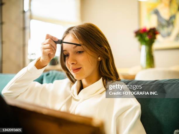 teenage girl make up session - eyebrow pencil stockfoto's en -beelden