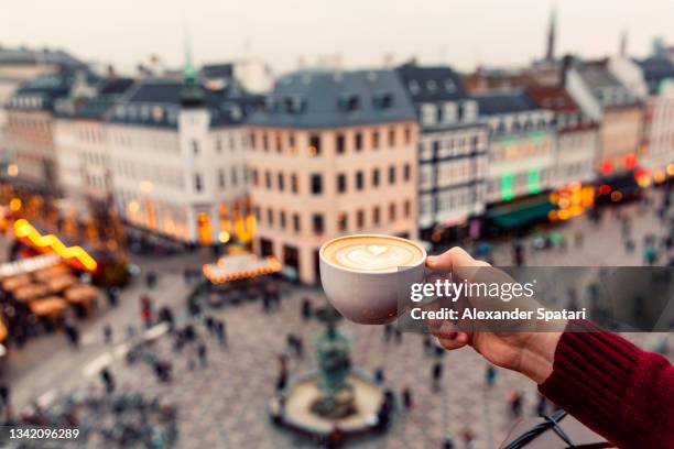 man drinking coffee with a view of copenhagen skyline, denmark - filmperspektive stock-fotos und bilder