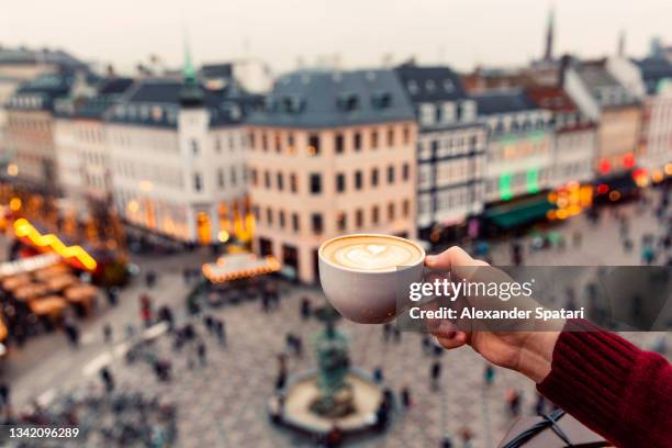 man drinking coffee with a view of copenhagen skyline, denmark - hygge stockfoto's en -beelden