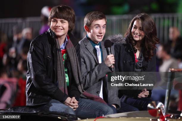Actors Brendan Mayer, Gig Morton and Matreya Fedor ride in the 80th Anniversary Hollywood Christmas Parade on November 27, 2011 in Hollywood,...