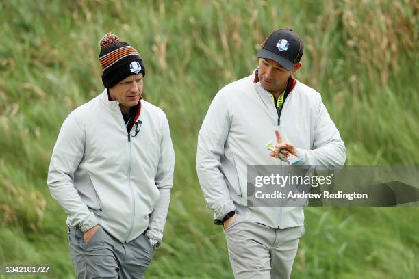 Vice-captain Luke Donald of England and team Europe and captain Padraig Harrington of Ireland and team Europe walk across the fifth hole during...