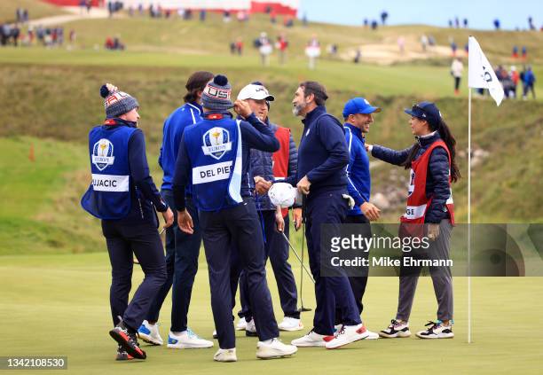 The group of Rob Riggle, A.J. Hawk, Alessandro Del Piero, and Sasha Vujacic shake hands on the 18th green after their round during the celebrity...