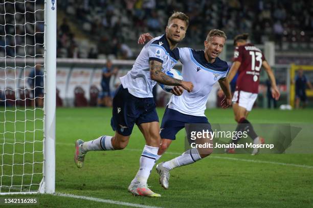 Ciro Immobile of SS Lazio celebrates with team mate Lucas Leiva after scoring a late penalty to level the game at 1-1 during the Serie A match...