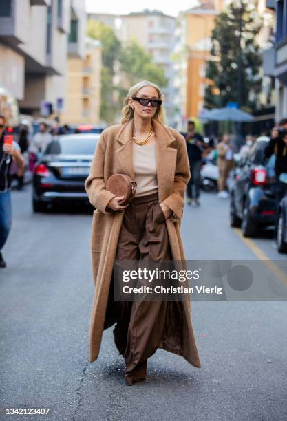 Leonie Hanne seen wearing brown wide leg pants, beige coat, round bag outside Max Mara during the Milan Fashion Week - Spring / Summer 2022 on...