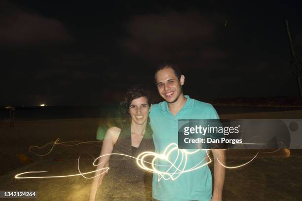smiling couple, a man and woman, special effect with multiple images and light streaks - multiple images of the same woman stock pictures, royalty-free photos & images