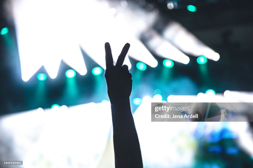 Peace sign hand symbol at music concert venue