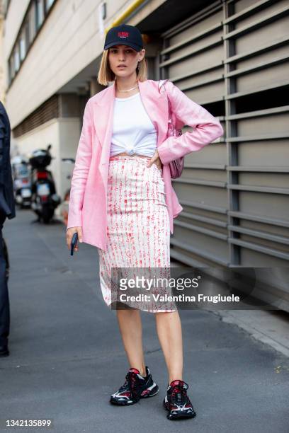 Julia Kulesh outside Etro fashion show wearing a pink blazer, white t-shirt, baseball cap and under the knee skirt during the Milan Fashion Week -...