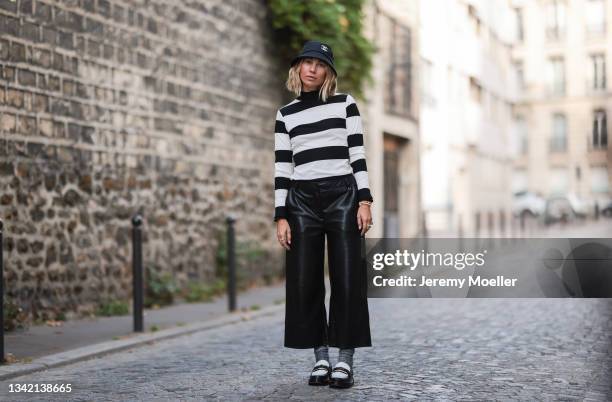 Karin Teigl wearing full comma fashion look, black Chanel bucket hat and black and white Louis Vuitton loafers on September 19, 2021 in Dusseldorf,...