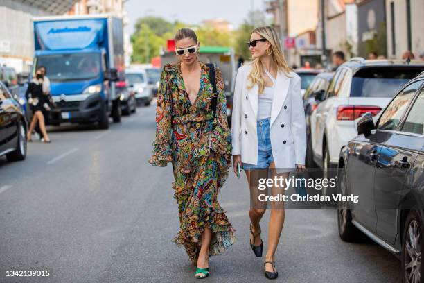 Ann-Kathrin Götze seen wearing dress with print and bag and Mandy Bork wearing blue Hermes bag white blazer, denim jeans outside Etro during the...