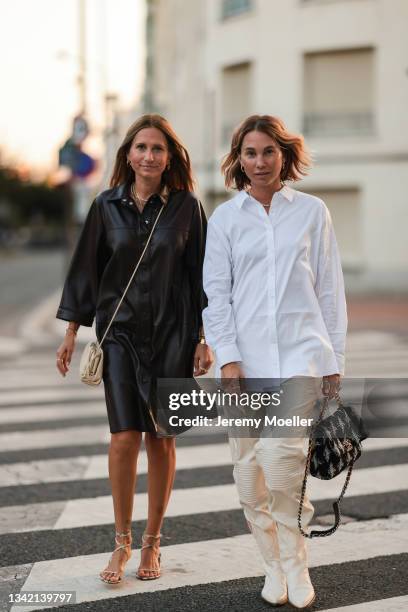 Michi Brandl wearing comma fashion look and beige Bottega Veneta leather bag, and Karin Teigl wearing full comma fashion look and black Chanel bag on...