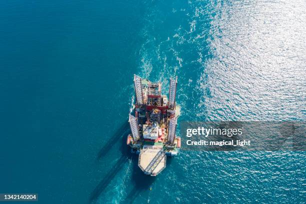 oil rig on offshore area stock photo. aerial view offshore jack up rig being towed to the location - boortoren stockfoto's en -beelden