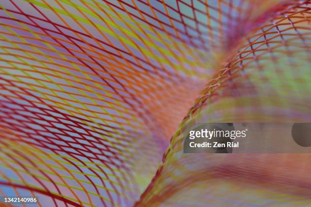 abstract image of a multi colored mesh ribbon in autumn colors - netz textilien stock-fotos und bilder