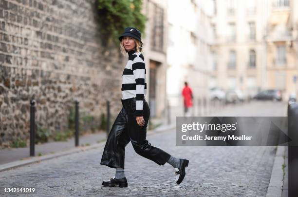 Karin Teigl wearing full comma fashion look, black Chanel bucket hat and black and white Louis Vuitton loafers on September 19, 2021 in Dusseldorf,...